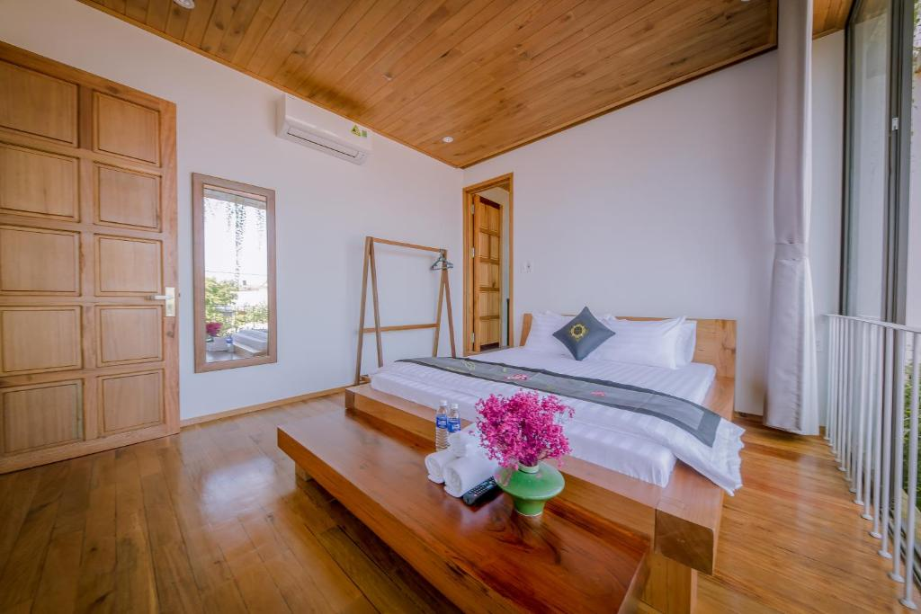 Room 1 — teak-floored room with a garden view